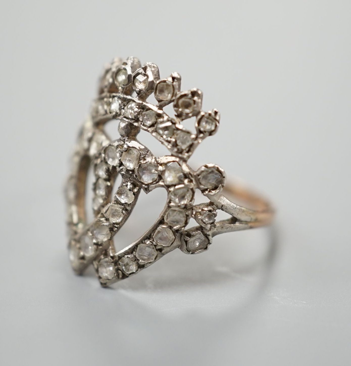 A 19th century, yellow and white metal, rose cut diamond set twin hearts and coronet ring, size K, gross weight 2.6 grams.